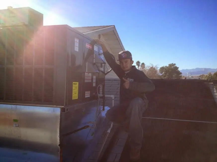 HVAC technician performing HVAC Inspection on a rooftop unit in Darien